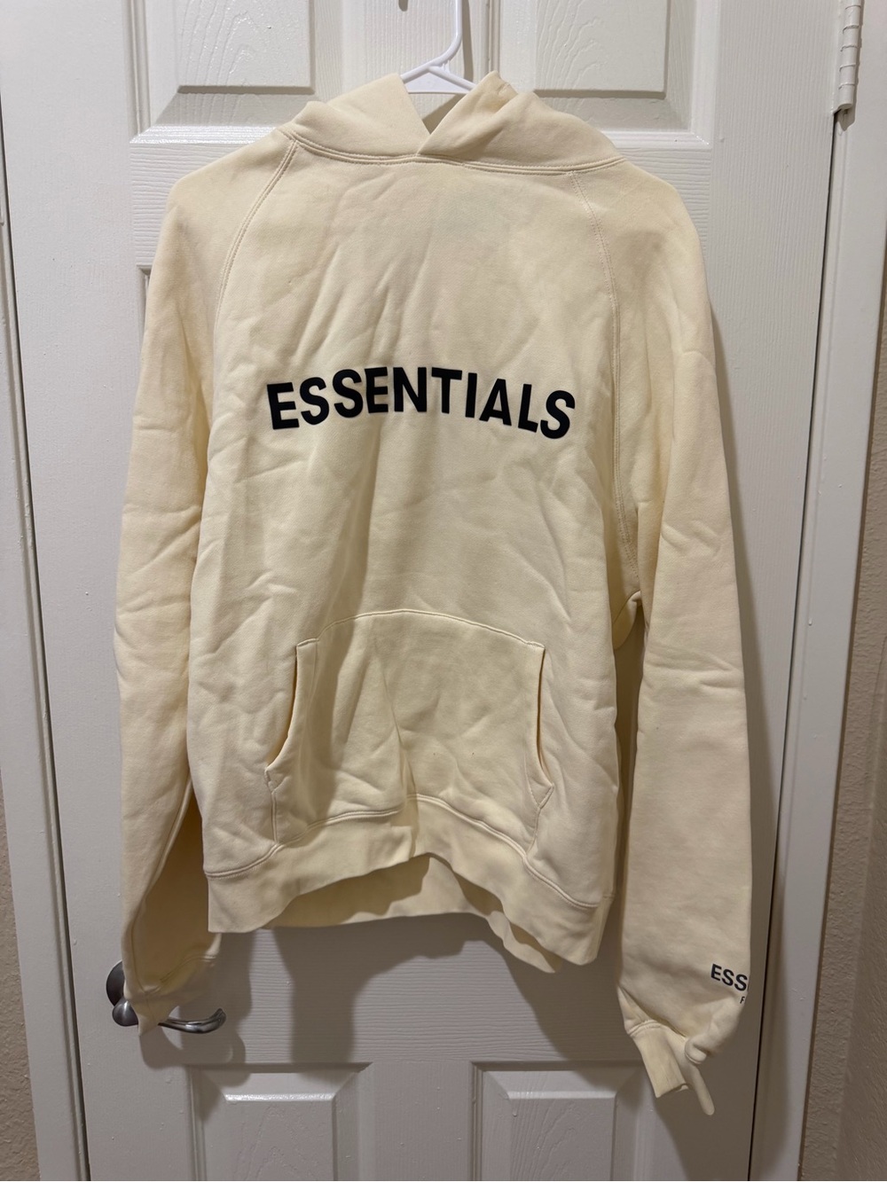 Fear of God Essentials Crewneck Hoodie in Cream with Black Logo